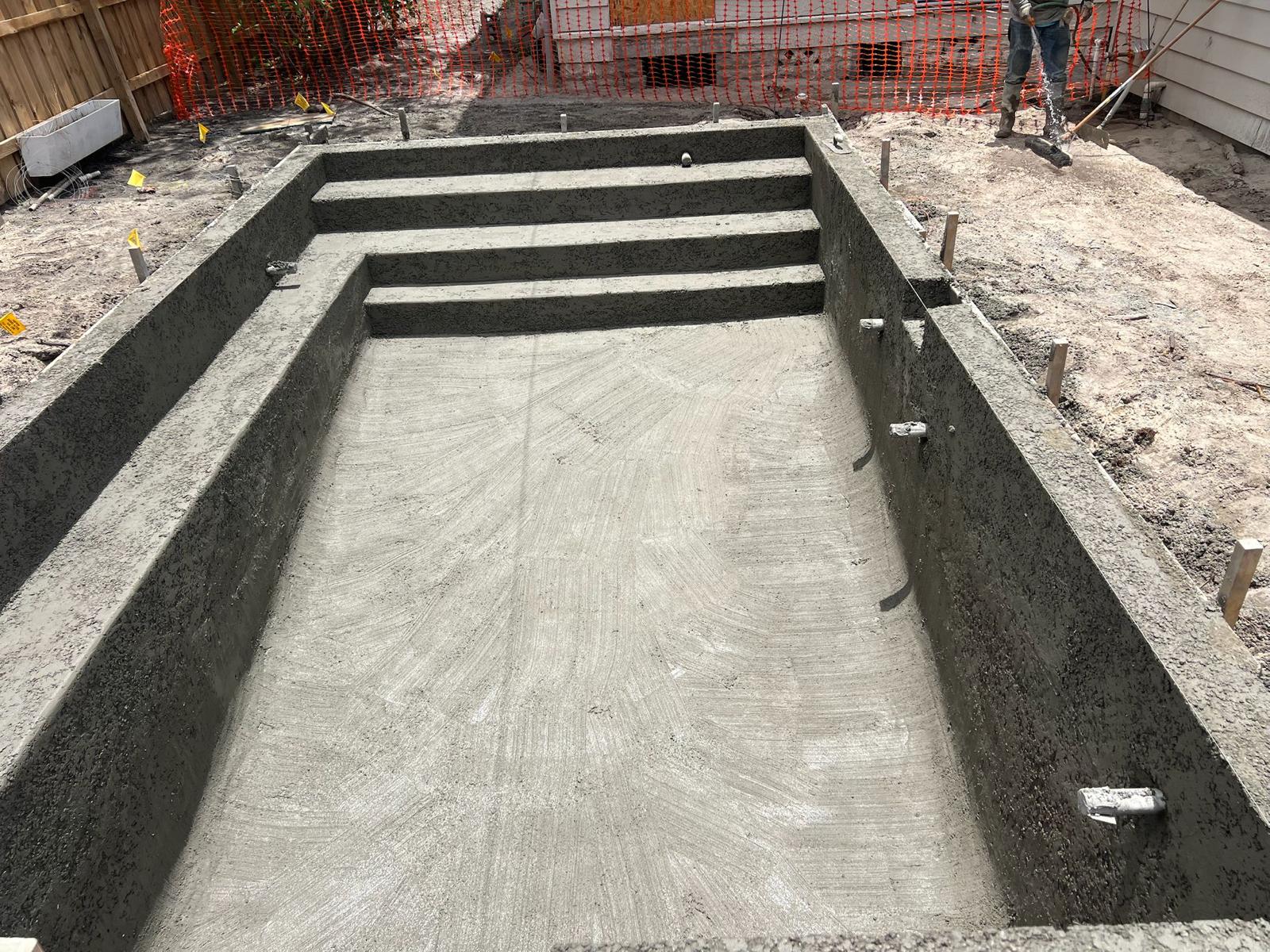 Concrete steps inside pool shell during early construction phase in Clearwater