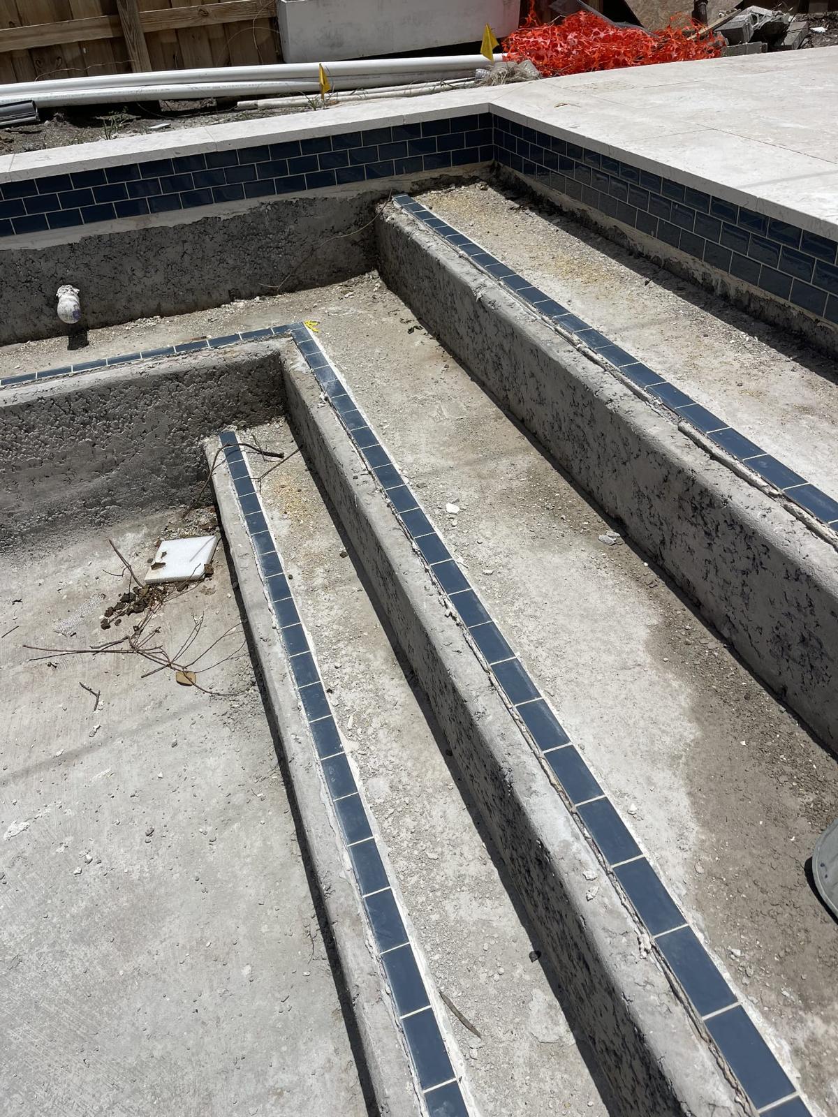 Poured concrete stairs inside a pool shell mid-construction in Clearwater