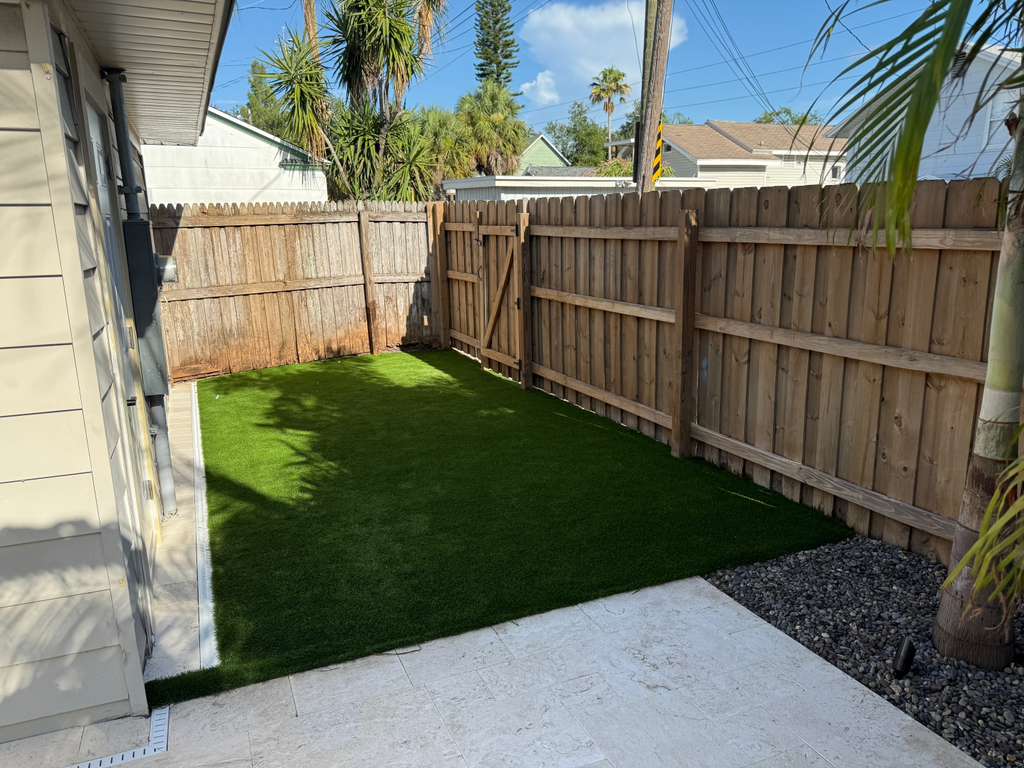 Artificial turf section beside concrete patio in Clearwater outdoor space